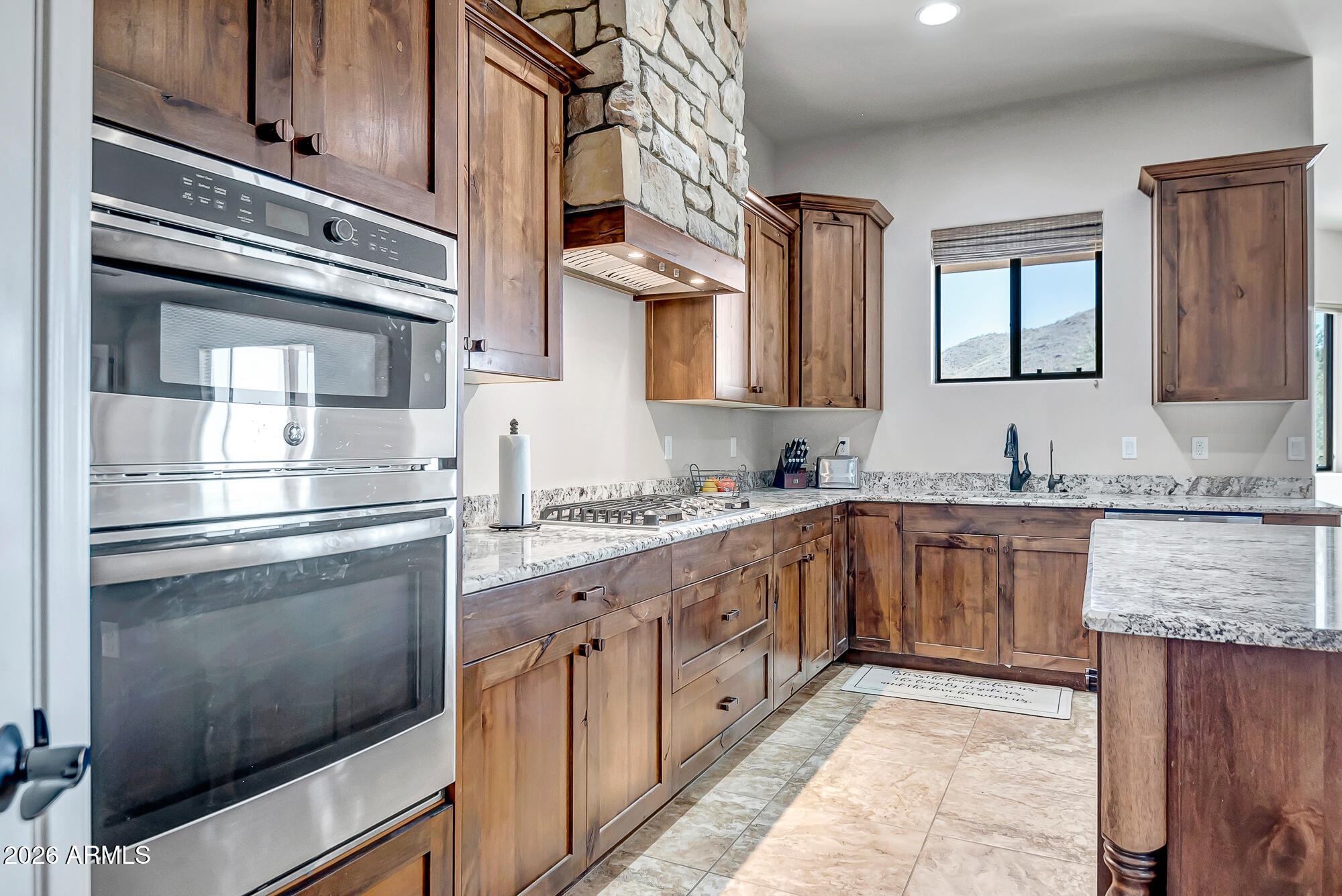 1121 East Saddle Mountain Road Phoenix, AZ 85086 - Photo 8 of 49 a kitchen with stainless steel appliances granite countertop a stove and a sink