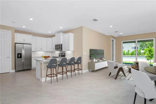 a living room with furniture a flat screen tv and a large window