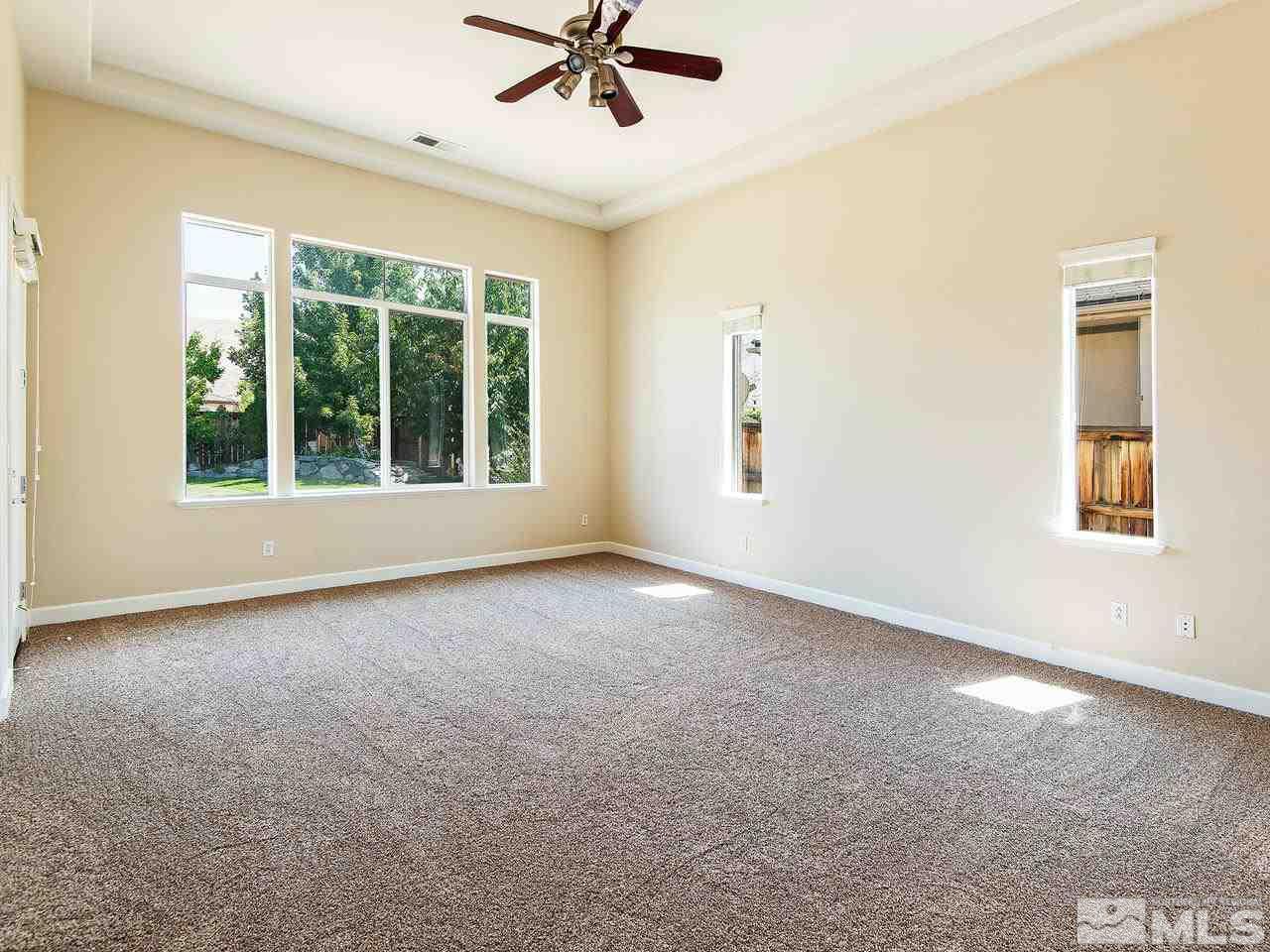 9980 Burghley Lane Reno, NV 89521 - Photo 7 of 24 a view of a livingroom with a ceiling fan and window