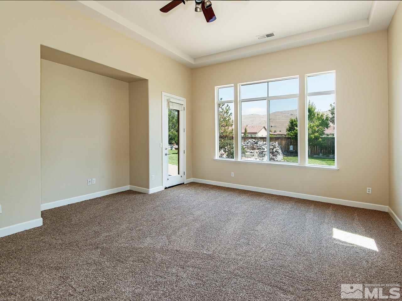 9980 Burghley Lane Reno, NV 89521 - Photo 8 of 24 an empty room with windows and city view