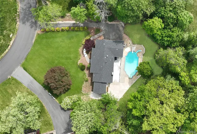 an aerial view of a house with a yard and lake view