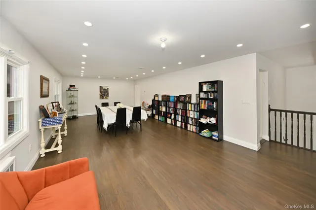 a living room with lots of furniture and a wooden floor