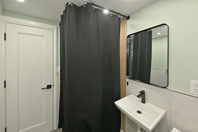 a bathroom with a sink and mirror