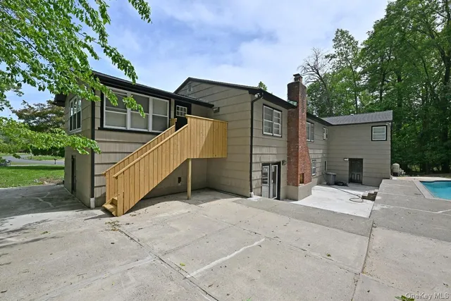 a view of backyard with a small cabin and chair