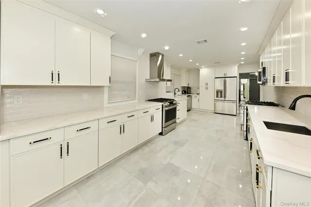 a kitchen with stainless steel appliances kitchen island granite countertop a sink and cabinets
