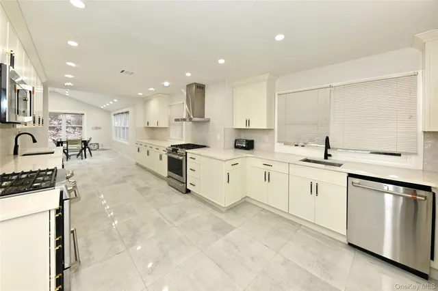 a kitchen with stainless steel appliances a sink stove and cabinets