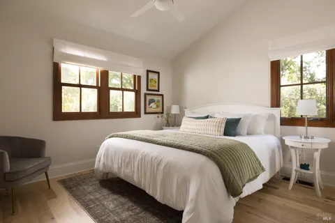 a bedroom with a bed and a large window