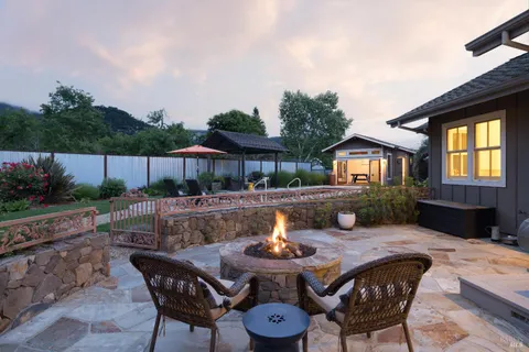 a view of house with backyard outdoor seating and hardwood