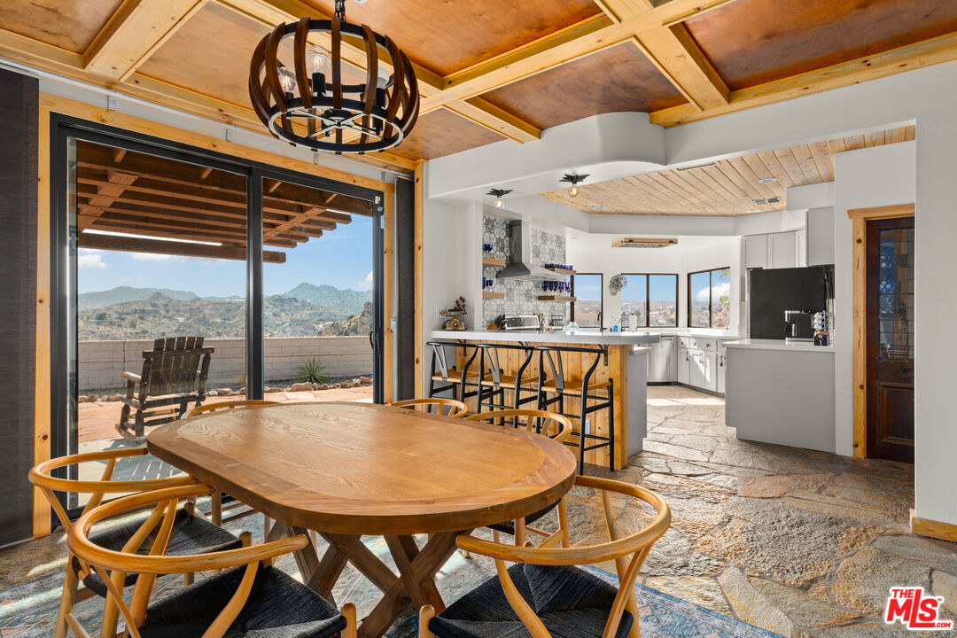 57387 San Juan Road Yucca Valley, CA 92284 - Photo 13 of 32 a view of a dining room with furniture window and wooden floor