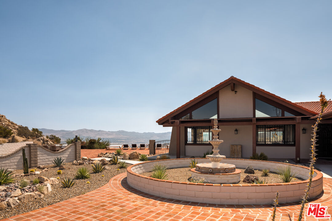 57387 San Juan Road Yucca Valley, CA 92284 - Photo 4 of 32 a view of a house with backyard porch and patio