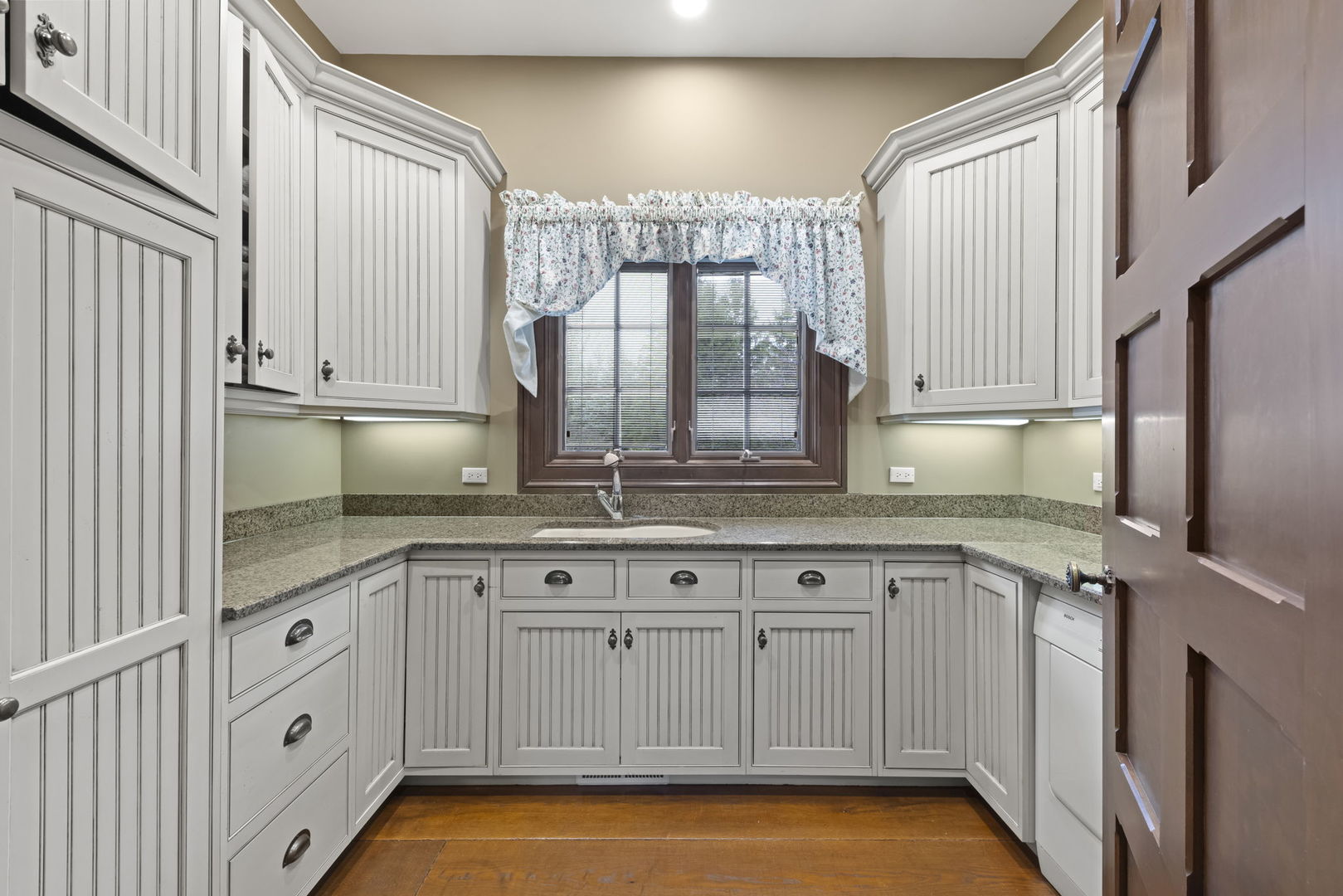 24W141 Hobson Road Naperville, IL 60540 - Photo 35 of 70 a kitchen with granite countertop white cabinets and sink