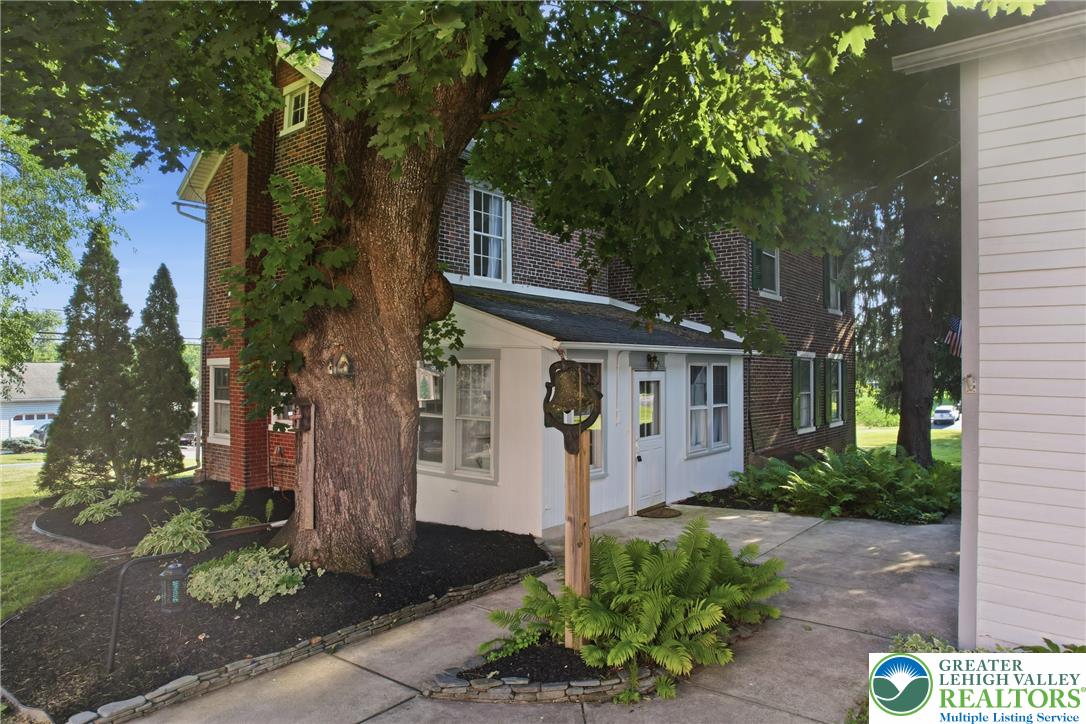 4682 Steuben Road Bethlehem, PA 18020 - Photo 77 of 79 Mature trees and lush landscaping frame this distinguished brick home with a welcoming front porch.