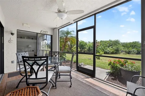 a view of a porch with furniture and wooden floor