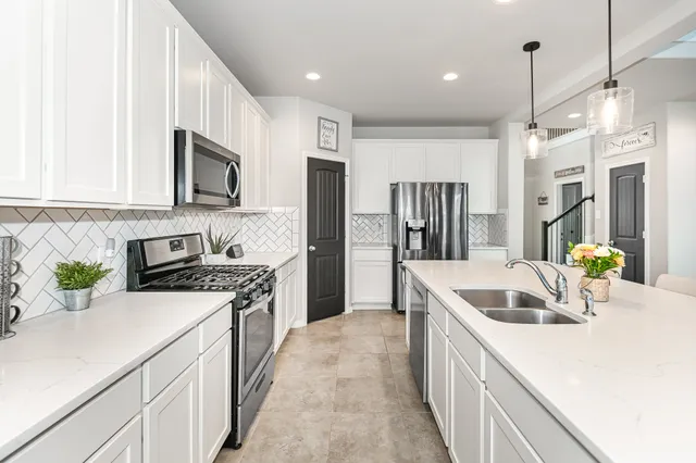 a kitchen with a sink stove and refrigerator