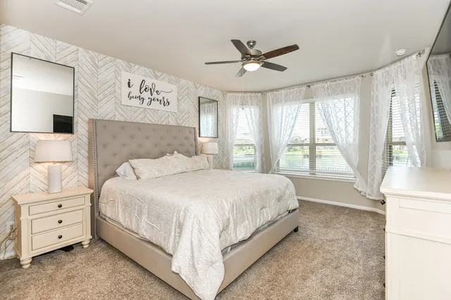 a bedroom with a large bed and a window