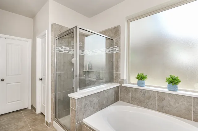 a bathroom with a tub and shower