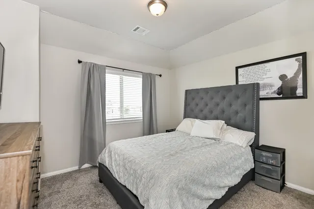 a bedroom with a bed and window