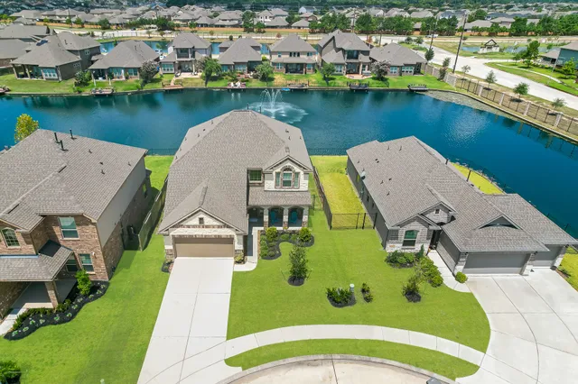 an aerial view of a house with swimming pool and outdoor space