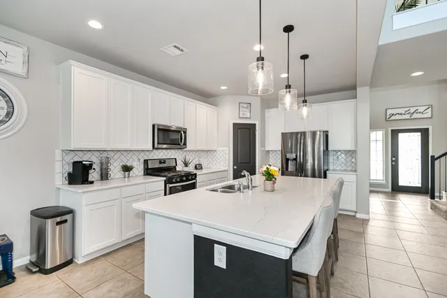a kitchen with a stove a sink and a refrigerator