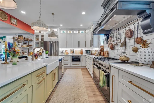 a kitchen with stainless steel appliances granite countertop lots of counter top space