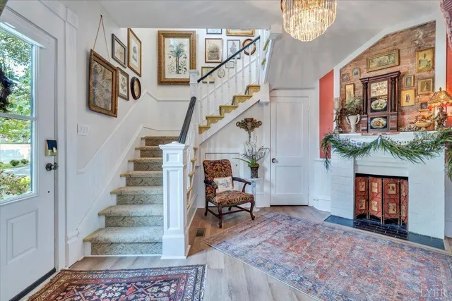 a kitchen with stainless steel appliances granite countertop a stove a sink and a chandelier