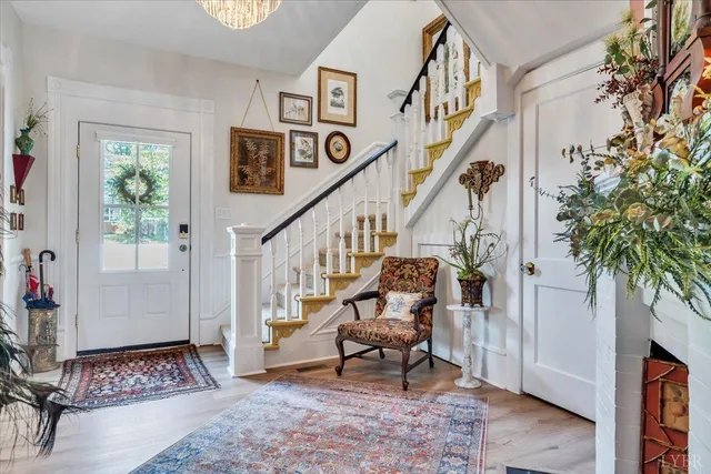 a living room with furniture a chandelier and a chandelier