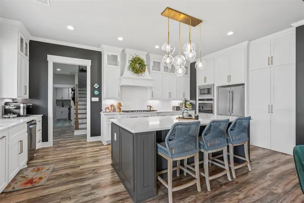 a large kitchen with granite countertop a counter space a sink appliances and cabinets