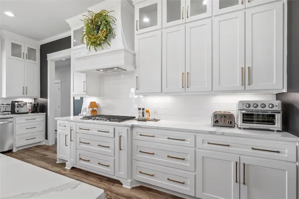 a kitchen with cabinets stainless steel appliances and cabinets
