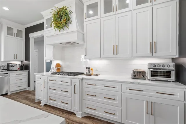 a kitchen with cabinets stainless steel appliances and cabinets