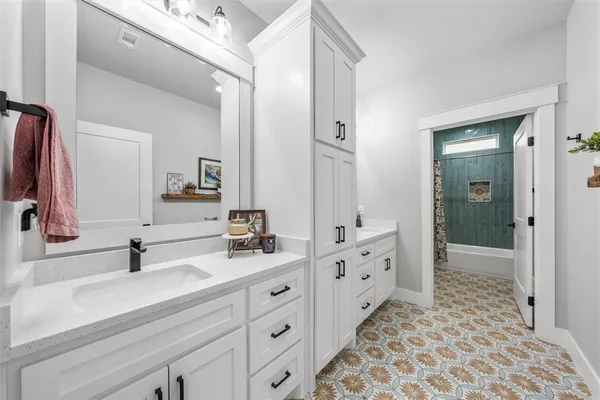 a bathroom with a double vanity sink and mirror