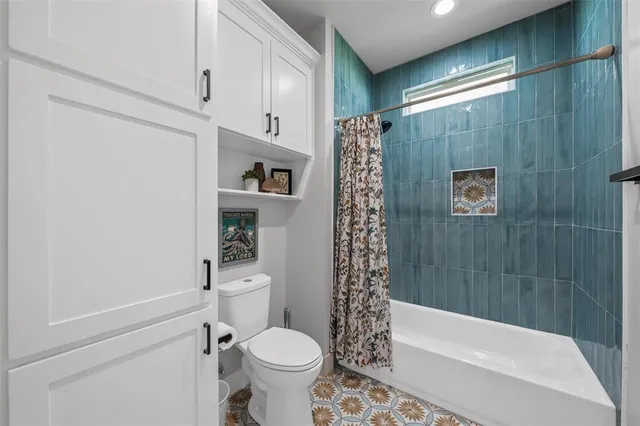 a bathroom with a toilet a sink and bathtub