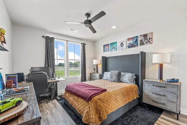 a bedroom with a bed a couch and a window