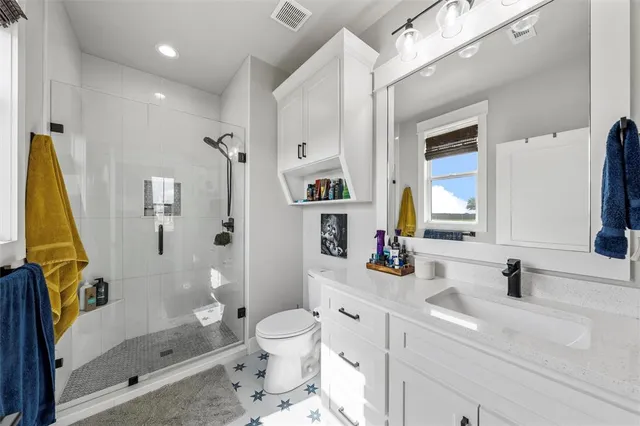 a bathroom with a sink toilet and shower