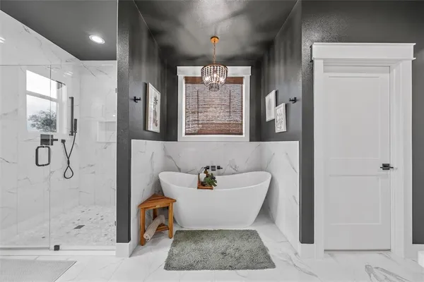 a bathroom with a bathtub shower and a mirror