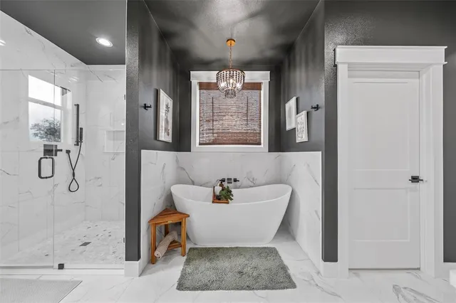 a bathroom with a bathtub shower and a mirror