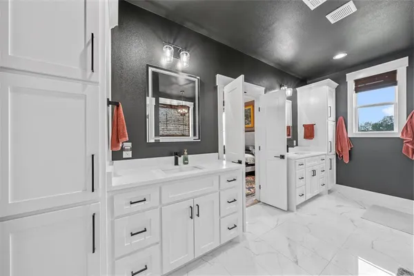 a bathroom with a double vanity sink mirror and