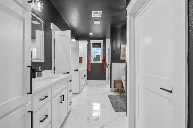 a bathroom with a double vanity sink and mirror