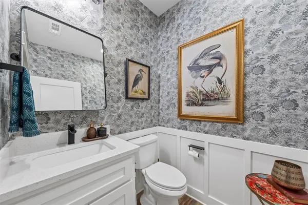 a bathroom with a toilet a sink and a mirror