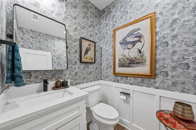 a bathroom with a toilet a sink and a mirror