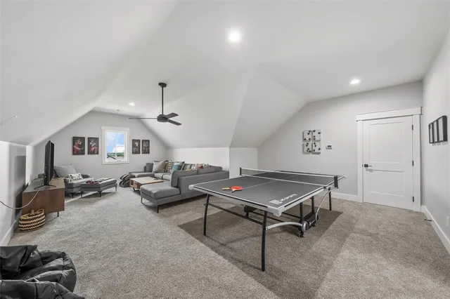 a living room with furniture a rug and gym equipment