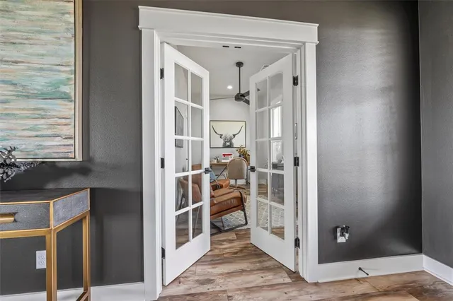 a view of a hallway with wooden floor and staircase