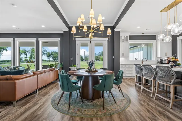 a view of a dining room with furniture wooden floor and chandelier