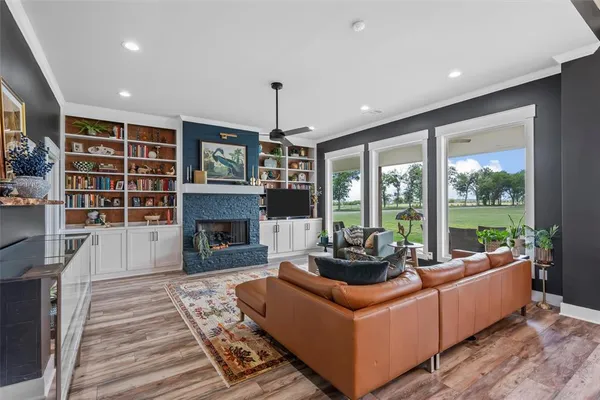 a living room with furniture a fireplace and a chandelier