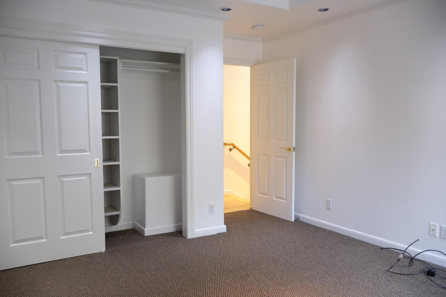 2360 Woodside Road, Unit A Woodside, CA 94062 - Photo 19 of 27 an empty room with closet and windows
