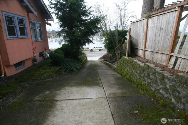 a view of house with backyard and deck