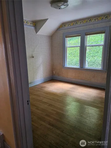 a view of a room with wooden floor and stairs