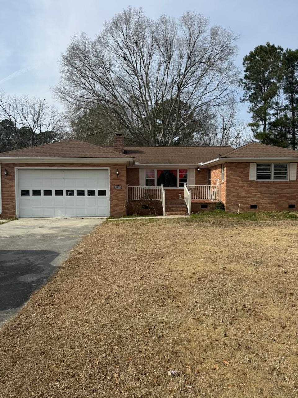 4625 Graham Street Loris, SC 29569 - Photo 1 of 11 Ranch-style home with crawl space, brick siding, a chimney, asphalt driveway, and covered porch