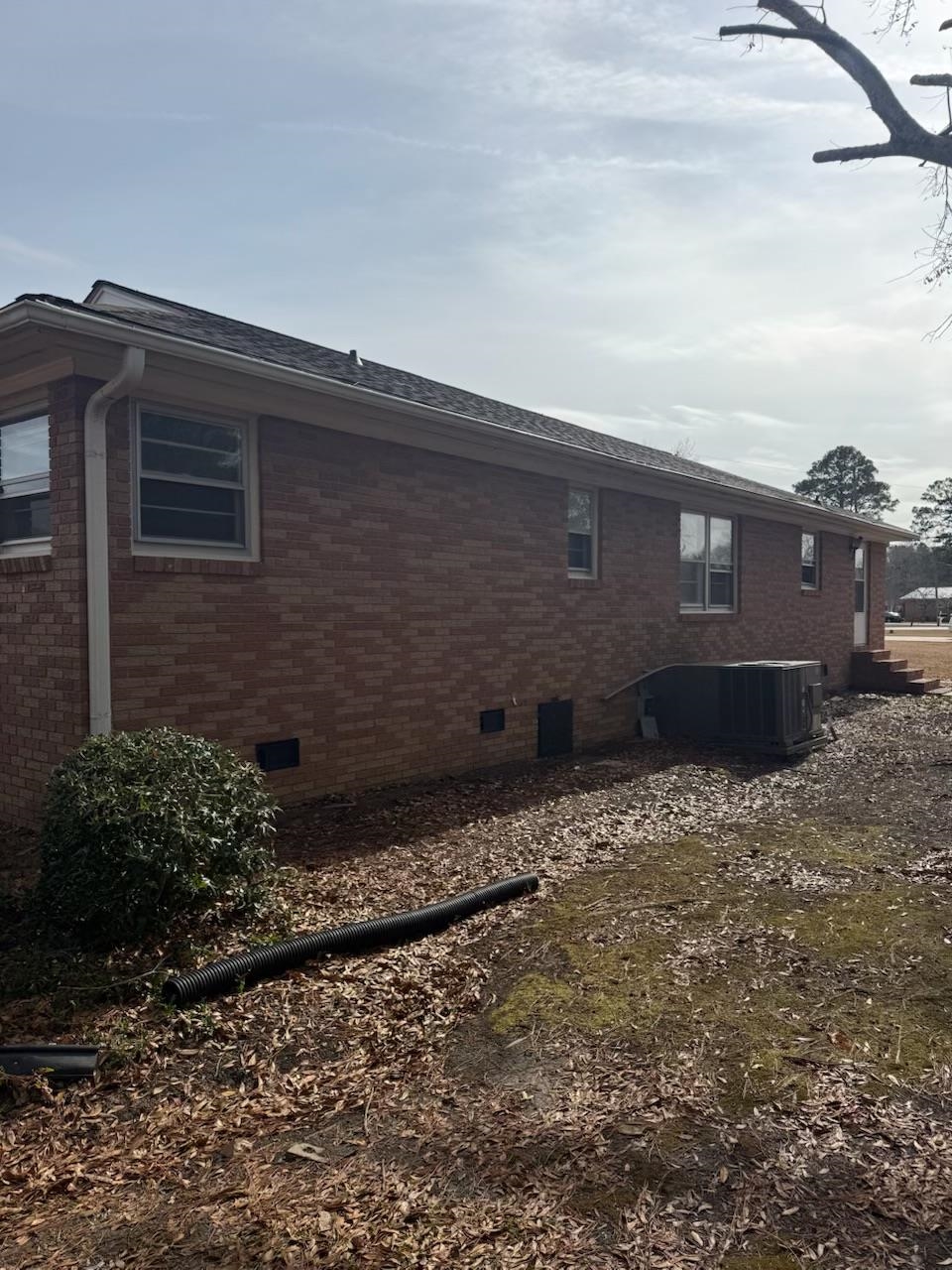 4625 Graham Street Loris, SC 29569 - Photo 4 of 11 View of side of home with crawl space, brick siding, and roof with shingles