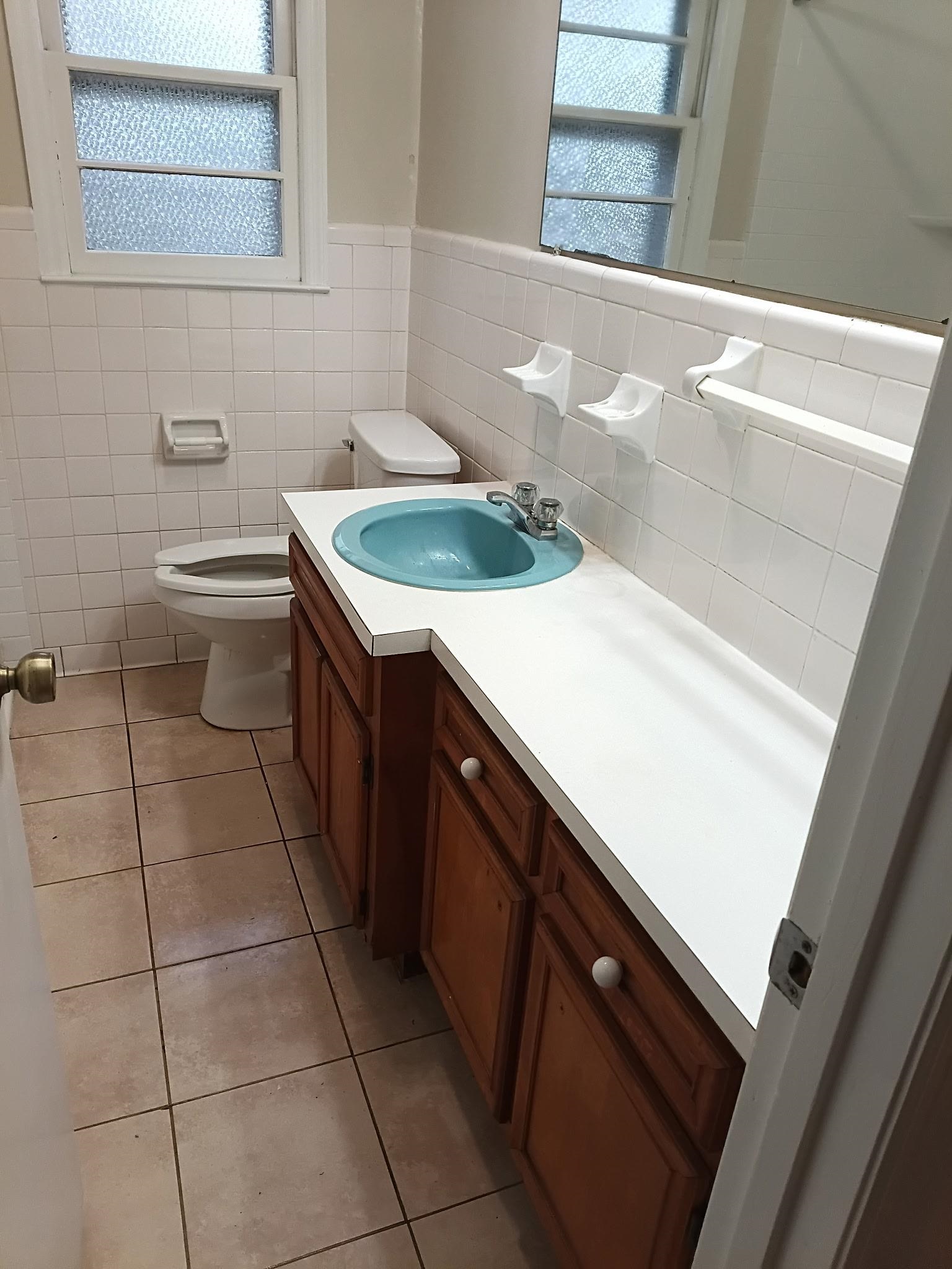 4625 Graham Street Loris, SC 29569 - Photo 7 of 11 Half bathroom with vanity, light tile patterned floors, a wainscoted wall, healthy amount of natural light, and tile walls