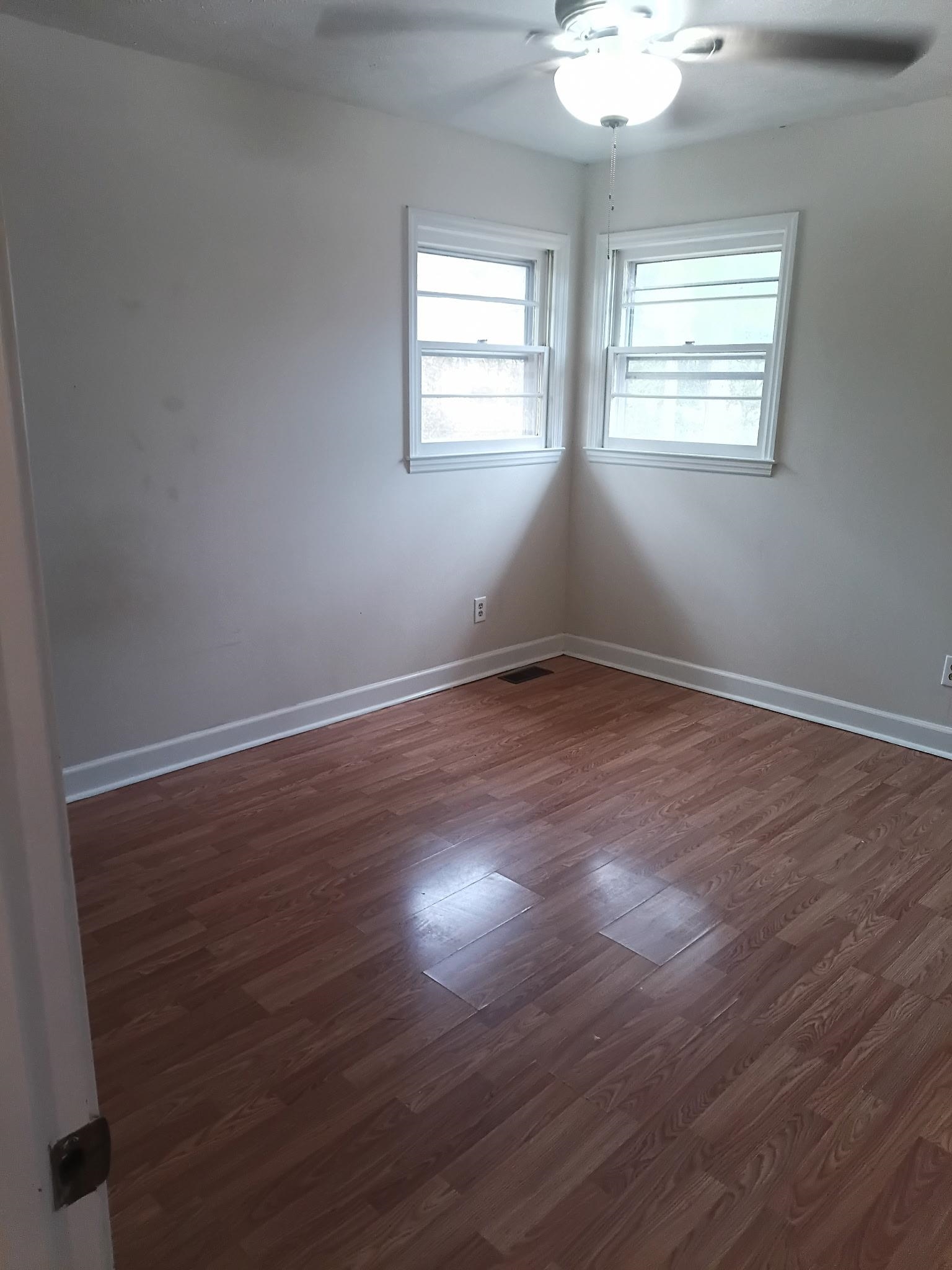 4625 Graham Street Loris, SC 29569 - Photo 9 of 11 Empty room featuring ceiling fan and dark wood-style flooring